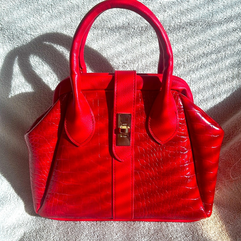 Red alligator inspired handbag with gold hardware